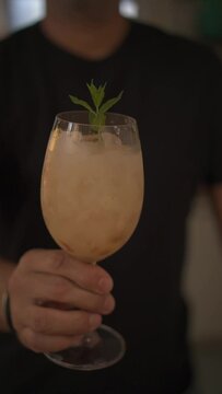Vertical view of a man preparing caipirinha with lichia