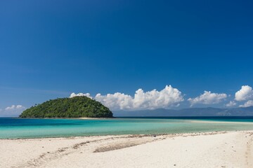 Beautiful view of the green island against the blue sky. Bon Bon Beach, Romblon, Philippines.