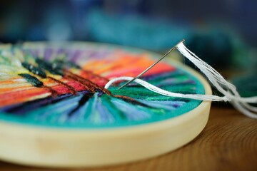 Closeup shot of a beautiful embroidery with a needle and thread