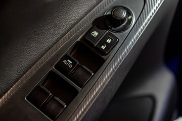 Closeup of the car window buttons on the driver's side