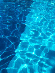 Water background, ripple and flow with waves. Summer blue swiming pool.