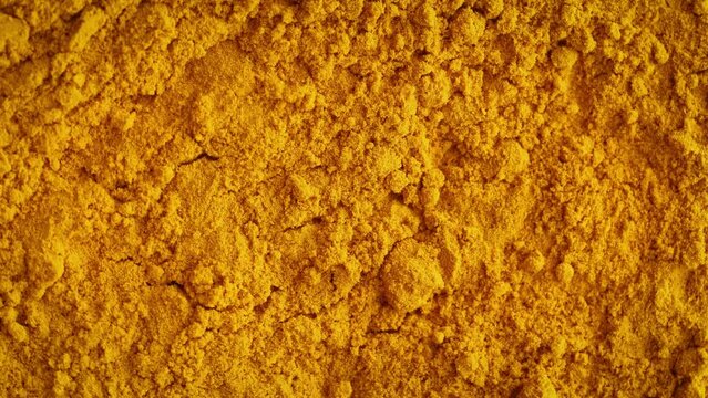 turmeric Curcuma yellow dried roots powder background