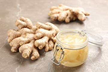 Fototapeta premium Spicy pickled ginger and root on grey table