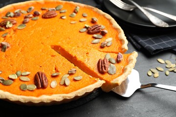 Delicious homemade pumpkin pie on black table, closeup