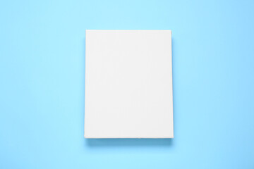 Blank canvas on light blue background, top view. Space for design