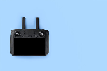 New modern drone controller on blue background, top view. Space for text