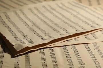 Many old note sheets as background, closeup