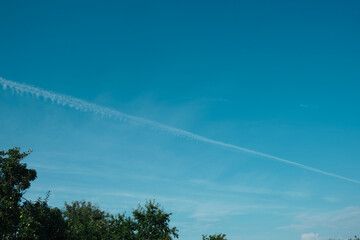 Traces of the jet engine of the plane in the summer sky