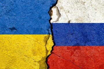 Ukraine vs Russia national flags icon painted on dirty cracked concrete background