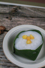 Thai Pudding with Coconut topping on banana leaf(Tako). Jelly coconut cream with corn and taro on top. Thai desert ,Famous
