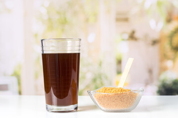 granulated panela and agua de panela or sugar cane sweets and lemon in the kitchen, typical food of Colombia
