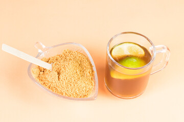 Panela granulated and agua de panela and lemon or candies made from sugar cane and lemon with copy...