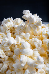 Still life photo of a stack of popcorn on black background, an image of a pile of popcorn isolated.
