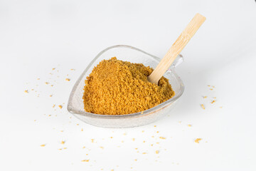 pulverized panela or sweet sugar cane on white background, typical food of Colombia