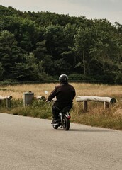 Vertical shot of a man riding motocycle