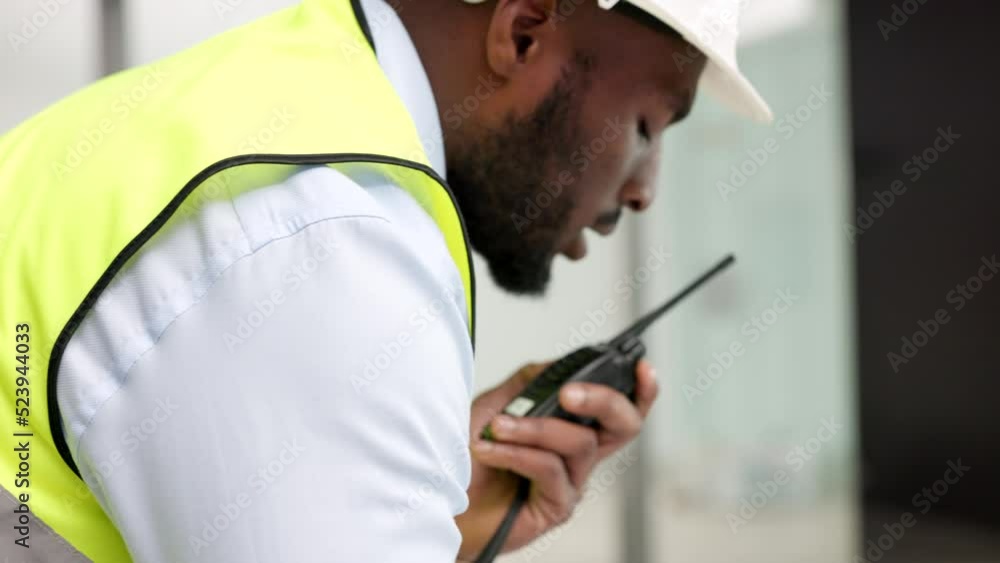 Poster builder, contractor and technician talking on radio transmitter walkie talkie while managing constru