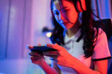 Asian beautiful Esport woman gamer play online mobile game on computer