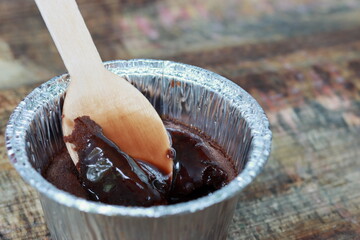 Delicious Lava with tasty Chocolate falling from . Chocolate Lava dessert on wooden background with spoon