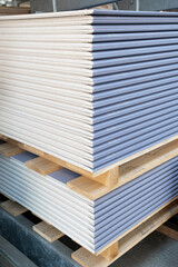 The stack of Special gypsum board with enhanced sound insulation Plasterboard. Panel Type DF for indoor concrete walls prepared for construction