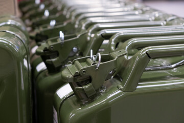 New green iron gas can in the hardware store. Fuel Tank for Transporting and Storing Petrol,...