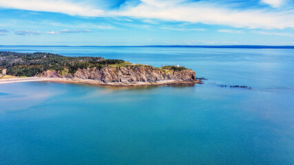 Obraz premium Aerial View of Rugged Coastal Cliffs and Turquoise Waters in Newfoundland, Canada