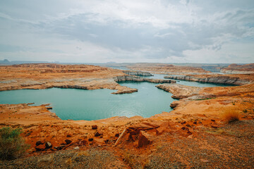 Lake Powell overlook. Red rocks, cliffs, bluffs, and cloudy sky on background