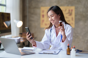 Asian female doctor discuss and discuss vaccine drug information and side effects with drug and vaccine specialists via video call in hospital.