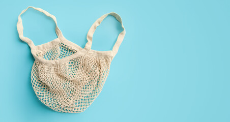 Fototapeta premium trendy eco friendly organic net bag isolated over blue background
