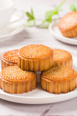 Traditional Chinese mid autumn festival mooncake on white wooden table