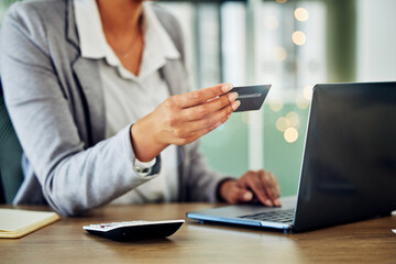 Digital banking, online shopping or internet business planning of a woman holding a credit card. A female accountant at a office computer checking finance data and working with financial information