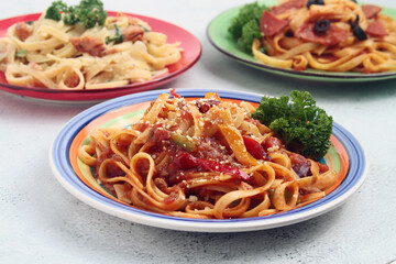 Freshly cooked fettuccine pasta in marinara or tomato sauce