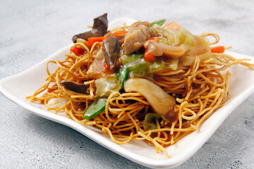 Freshly cooked Chinese food called crispy noodles with meat and vegetables
