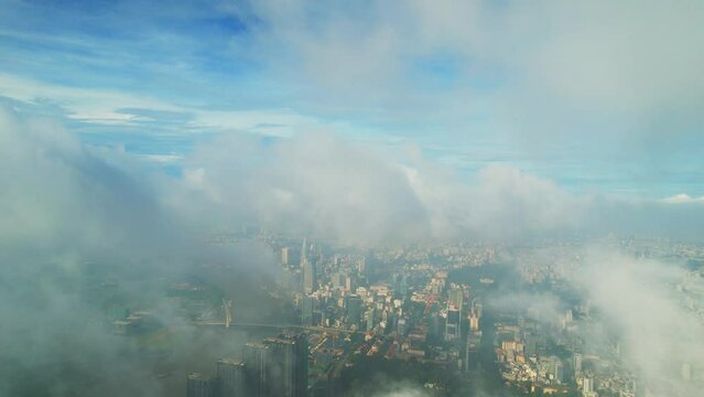 Top view aerial through the clouds of a Ho Chi Minh City, Vietnam with development buildings, transportation, energy power infrastructure in Ho Chi Minh city, Vietnam