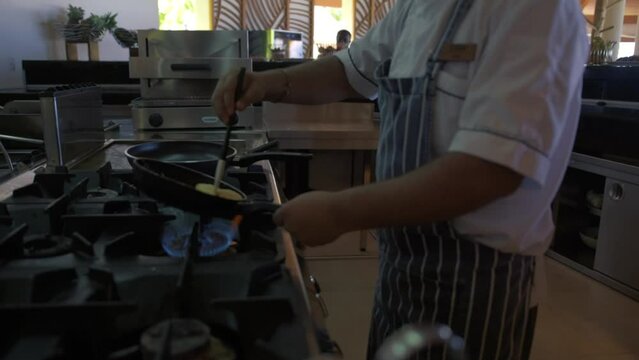 A chef in a Maldives resort breakfast diner makin an Omlet. Full HD Slow Motion