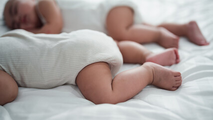 The baby is lovely, sleeping happily and relaxing in bed.