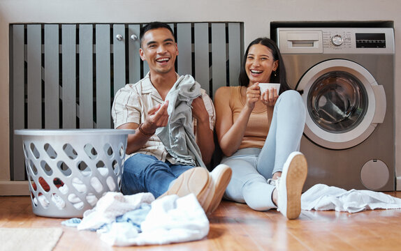 Happy, relaxed and responsible couple doing laundry, household chores or cleaning together on the weekend at home. Young millennial boyfriend and girlfriend enjoying their new modern washing machine