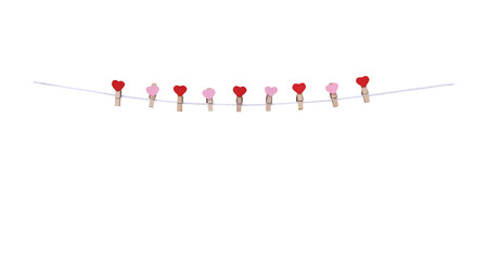 Nine wood clothes clip with red and pink heart shape patterns  hanging on white string line isolated on white background , clipping path