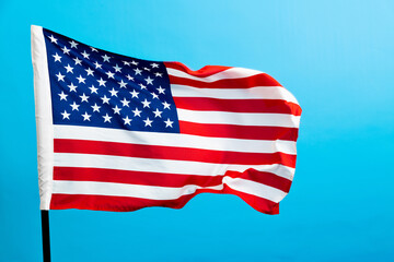 American flag waving on blue background