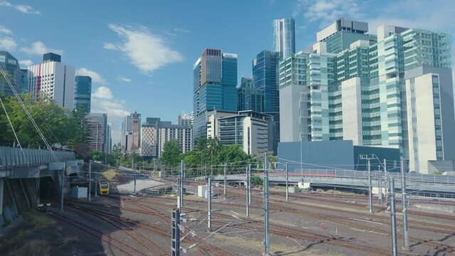 Passenger train in Brisbane with city skyline background