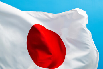Japan flag waving on blue background