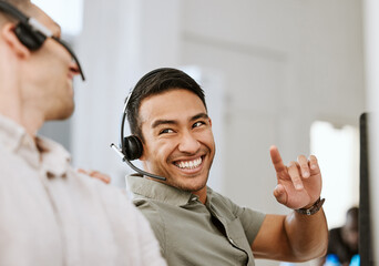 Happy, smiling and laughing call center agent at an insurance company talking to colleague at a...