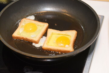 Almaty, Kazakhstan - 08.28.2015 : Breaking quail eggs into bread toasts for toasting.