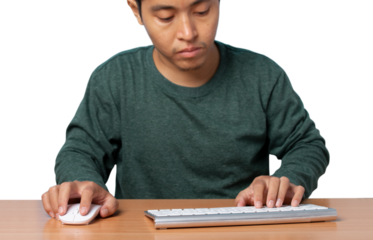 Young man using wireless mouse and keyboard.