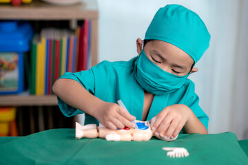 Asian boy play surgery with toy