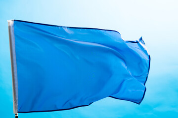Light blue flag waving on white background