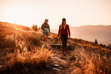 Traveler hiking with backpacks. Hiking in mountains. Sunny landscape. Tourist traveler on...