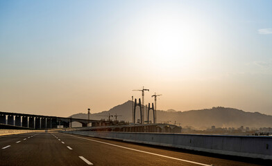Fototapeta na wymiar Construction of bridge under sunset