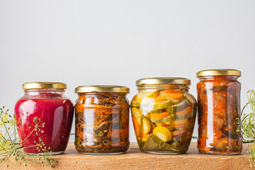 Harvesting vegetables for the winter, canned vegetables in jars on a wooden table, pickled or fermented vegetables, copy space