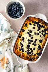 Delicious sweet cheesecake with blueberries in an oval dish, top view