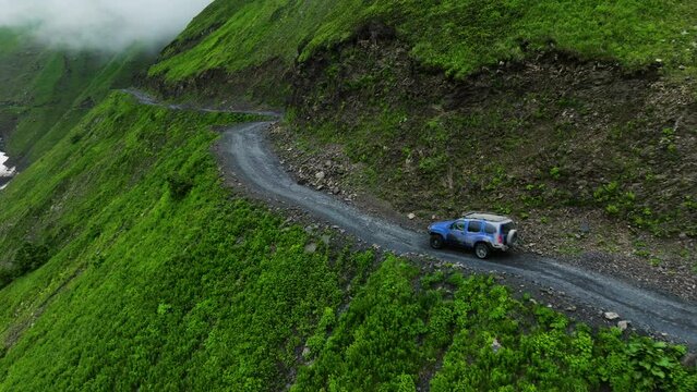 Aerial View Of An SUV Driving On Dangerous Death Road Through Abano Pass In Tusheti, Georgia. drone shot